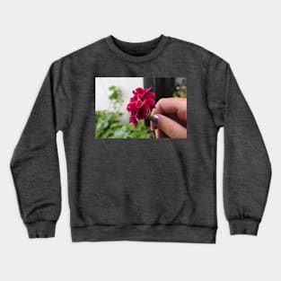 Hand with geranium flower Crewneck Sweatshirt